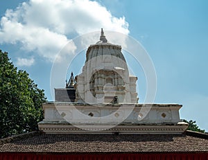 Shikhara peak of a Hindu temple against the blue sky in Durbar Square in Kathmandu.