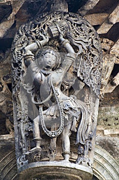 Shilabalika, celestial maiden, as a Dolu Kunita. A lady is palying a drum and dancing . Chennakeshava temple, Belur, Karnataka. No