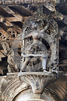 Shilabalika, celestial maiden, as a Huntress. Lady aiming arrow at the bird. Chennakeshava temple, Belur, Karnataka. Notice the ha