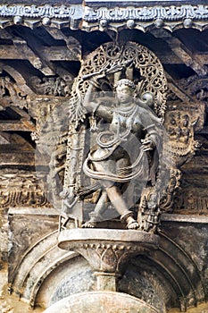 Shilabalika, celestial maiden, as a Kapikupite. Monkey, in the bottom left corner, pulling Saree. Chennakeshava temple, Belur, Kar