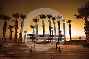 Shilouette of park bench at sunset.