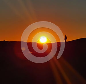 Shiluette in the sunset on the dunes