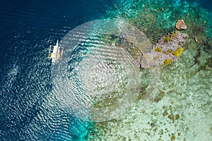 Shimizu Island, El Nido, Palawan, Philippines. Beautiful top down aerial view of lonely hopping trip boat in shallow