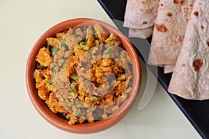 Shimla Mirch Zunka, Besan Capsicum Sabzi, a spicy Maharashtrian dish, served with bhakri or chapati