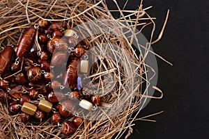 Shimmering brown abstract beads in an improvised nest