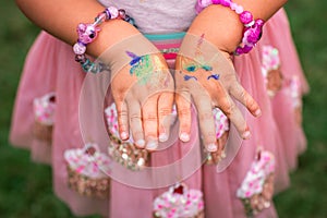 Shimmering sparkling glitter tattoo on a child& x27;s hand at a birthday party