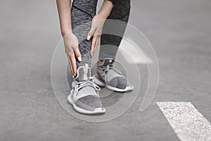 Shin Splints. Female Jogger suffering from sport trauma while running outdoors