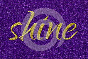Shine lettering word gold on ultra violet glitter texture. Shiny sparkle background