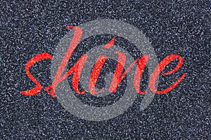 Shine lettering word grenadine red on gray midnight blue black glitter texture. Shiny sparkle background