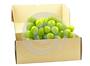Shine Muscat grape on a brown box isolated on a white background.