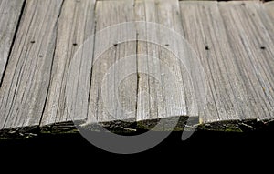 Shingled wooden roof on a building in the open-air museum. Roof and gutters gutters. The elements are made of chipped wooden hand-