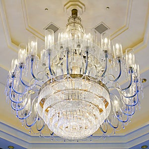 Shining chandelier hanging on a ceiling in hotel