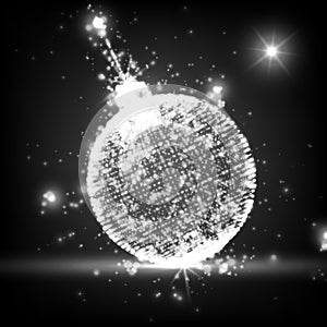 Shining Christmas ball on the monochrome background with glowing particles flying around.