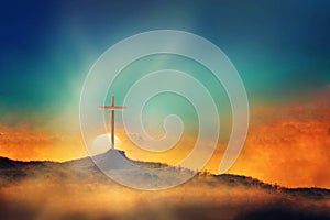 Shining cross on Calvary hill, sunrise, sunset sky background. Copy space. Ascension day concept. Christian Easter