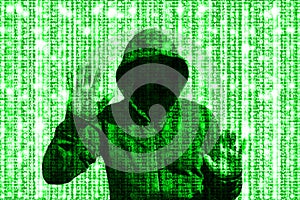 Shining green hacker behind computer code matrix