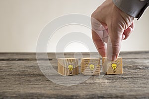 Shining light bulbs drawn on wooden blocks