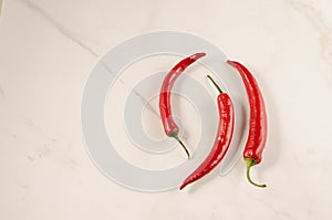 Shining red hot pepper on a marble background/red hot pepper on