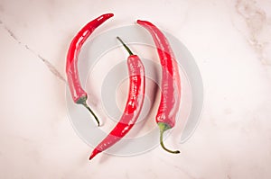 shining red hot pepper/red hot pepper on a white marble background. Top view