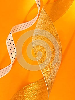 Shining ribbons on an orange background