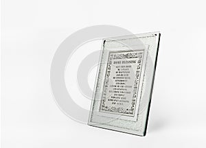 A shining silver picture frame with blessing home on white background