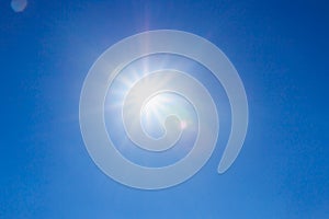 Shining sun at clear on blue sky background