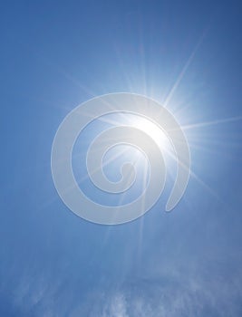 Shining sun on clear blue sky with lens flare of sunlight on sky background Bright sun on blue sky Concept Nature and environment