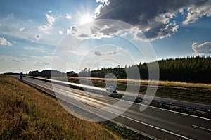 Shining sun over the highway, rays of light