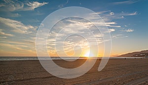 Shining sun over Santa Monica shore at sunset