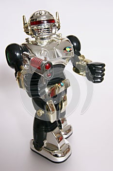 Shining toy robot aiming with a gun