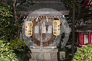 A shinto altar with lanters and praying cards.