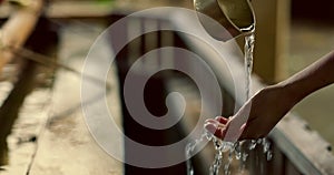 Shinto temple, closeup and washing hands with water in container for cleaning, faith and wellness. Religion, mindfulness