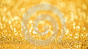 Shiny abstract textured background with golden lights, bokeh. Christmas, new year concept. Festive gold backdrop