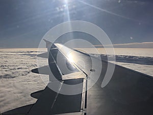 shiny airplane wing over clouds