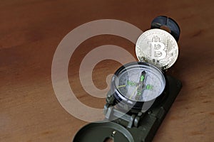 Shiny Bitcoin on a compass photo