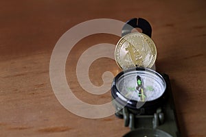 Shiny Bitcoin on a compass photo