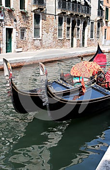Shiny black gondolas in the canals of Venice