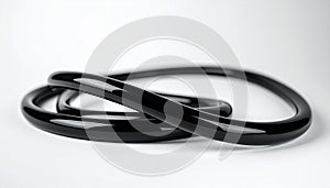 Shiny black rubber Oring lying on white surface