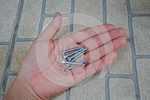 Shiny bolt in people hand for fastening structure