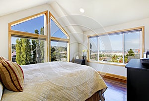 Shiny and bright bedroom with vaulted ceiling and beautiful view