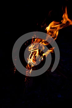 Shiny burning fire in the dark shows the romantic side of a campfire or bonfire, fire safety and the need of a fire insurance