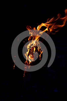 Shiny burning fire in the dark shows the romantic side of a campfire or bonfire, fire safety and the need of a fire insurance