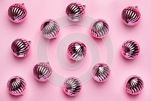 Shiny Christmas balls for decoration on pink background , new year pattern