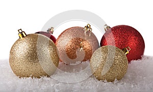 Shiny christmas balls on snow