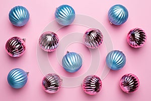 Shiny Christmas blue balls for decoration on pink background , new year pattern