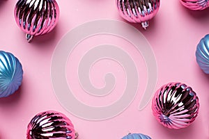 Shiny Christmas blue and pink balls for decoration on pink background with copyspace, new year ball