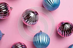 Shiny Christmas blue and pink balls for decoration on pink background , new year ball