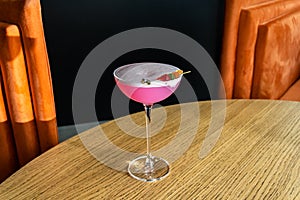 Shiny cocktail glass with fresh pink alcohol drink and jelly bears. Beverage and drinks backgrounds