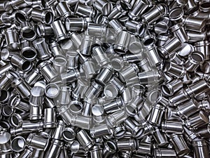 Shiny cold deformated cylindrical steel parts flat background photo