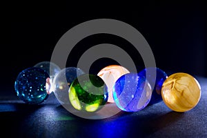 Shiny Colorful Translucent Glass Balls Against Black Background