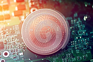 Shiny copper SERENETY cryptocurrency coin on blurry motherboard background